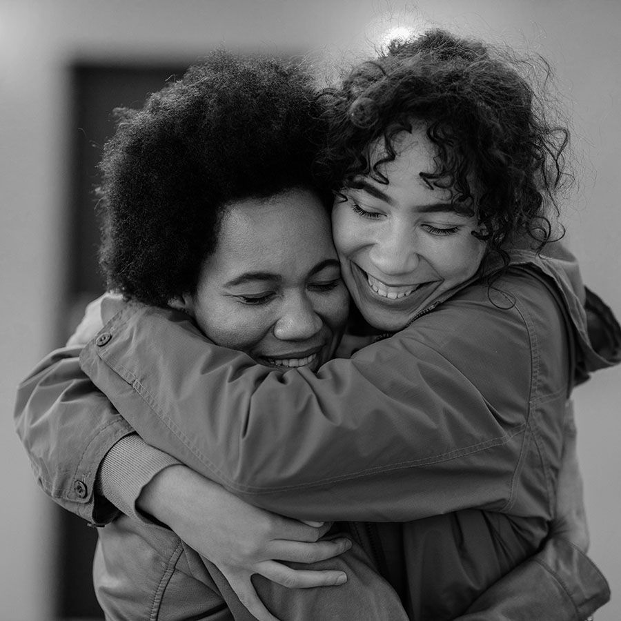 young women of color embracing